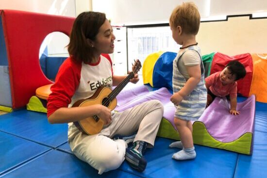 Teacher at our Chinese playgroup singing to toddler